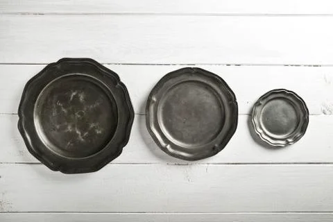 Tin texture plates on table Stock Photos