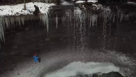 Tinker Falls Man Repels over Falls with Pan &amp; Tilt Stock-Footage 107402940