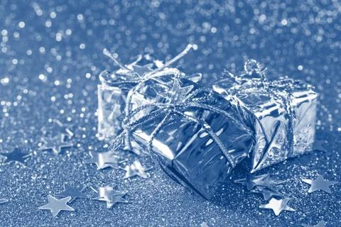 Tinted small gift boxes on shiny background with stars Stock Photos
