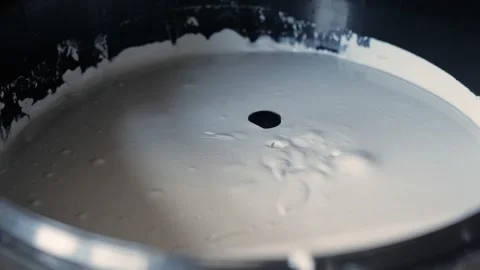 Tinting machine. a bucket of white paint, yellow jet mixes with black drop Stock Footage