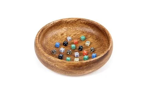 Tiny 6 sided dice in a wooden bowl over white Stock Photos
