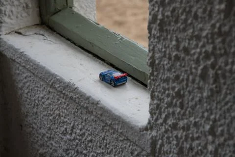 A tiny abandoned toy car left in an old shelter on the coast Stock Photos