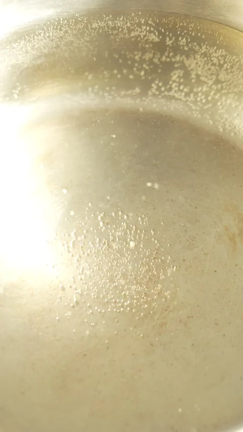 Tiny air bubbles cling to the bottom and sides of the pan 스톡 동영상 329607234