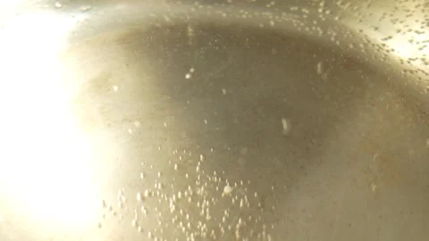 Tiny air bubbles cling to the bottom and sides of the pan Stock Footage 329607235