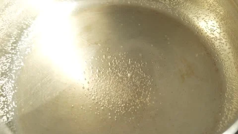 Tiny air bubbles cling to the bottom and sides of the pan 스톡 동영상 329607243