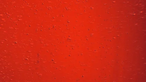 Tiny air bubbles raising in red abstract liquid Stock Footage 122257540