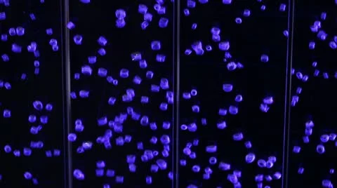 Tiny air bubbles rise in water against a black background Stock Footage 22358057