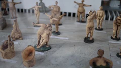 Tiny artistic sculptures depicting playful human figures in various poses on a m Stock Footage 300540347