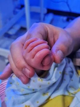 Tiny baby hands Stock Photos