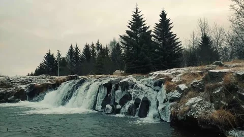 Tiny beautiful waterfall in a cozy little park in a moody winter day Video stock 145545573