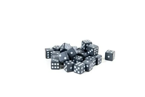Tiny black and white dice pile isolated over white Stock Photos