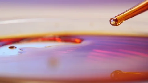 Tiny blobs of red blood crawling from a glassy pipe on a large sauce with blood Stock-Footage 127216213