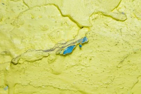 A tiny blue crab on textured yellow surface a unique wildlife scene Фото