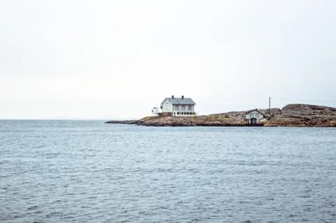Tiny blue lighthouse on swedish coastline Stock Photos