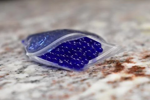 Tiny Blue Orbs in a Plastic Pouch Foto stock