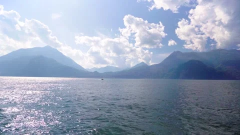 Tiny boat driving on Lake Como Italy wide shot Stock Footage 277275273