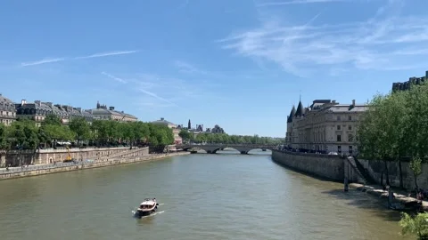 Tiny boat moves across Seine river at Paris city centre. Paris, France Stock Footage 284115316