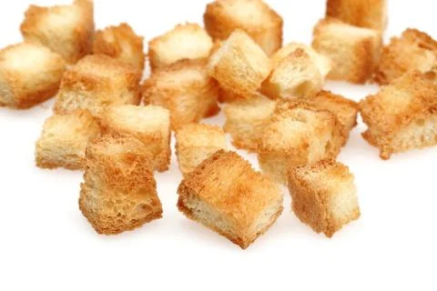Tiny bread cubes, croutons isolated on white Foto stock