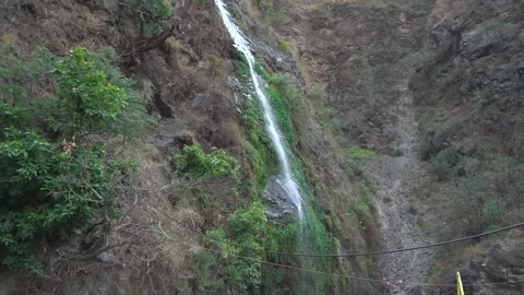Tiny bright waterfall shining &amp; falling in the dark forest background. Video stock 278545132
