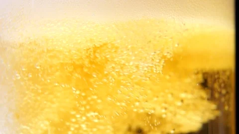 Tiny bubbles swirling in a beer glass. Stock Footage 241495281