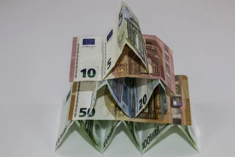 A tiny building made of different Euro banknotes Photos