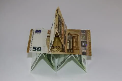 A tiny building made of different Euro banknotes Stock Photos