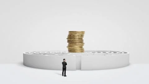 A tiny businessman standing in front of a white round maze with a stack of giant Stockfoto's