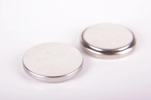 Tiny button cell batteries both sides isolated Stock Photos
