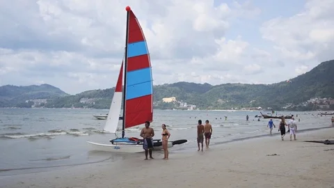 Tiny Catamaran Sailboat for Rent on Crowded Patong Beach Video stock 74629671