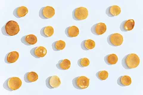 Tiny cereal pancakes pattern on white background Stock Photos