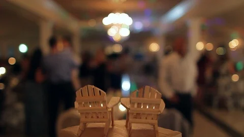 Tiny chair topper on top of cake depth of field people background blurry 스톡 동영상 92142476