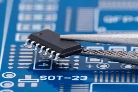 Tiny chip rests on circuit board Stock Photos