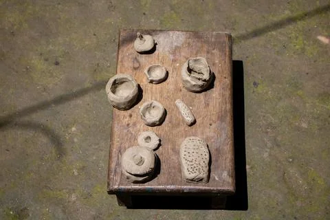 Tiny clay kitchen set. Kids' toys are made of clay. Making small toys with so Stock Photos