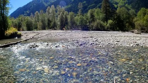 Tiny clear cold stream with boulder stones in Arkhyz mountains Stock-Fotos