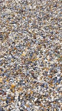 Tiny colored pebbles with visible details. background or texture 写真素材