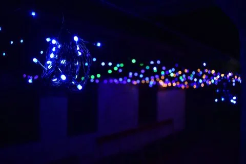 Tiny colorful lights selective focus with blurred bokeh on a black night back Stock Photos