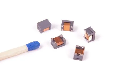 Tiny common mode choke filter in comparison with match head Stock Photos
