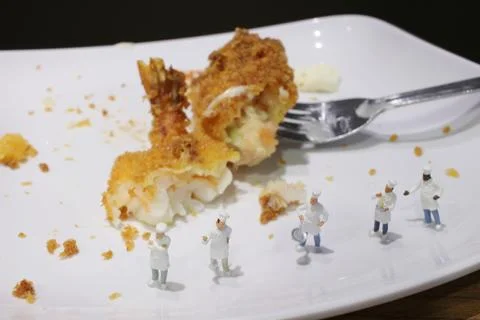 Tiny of cook are talking in the kitchen. Stock Photos