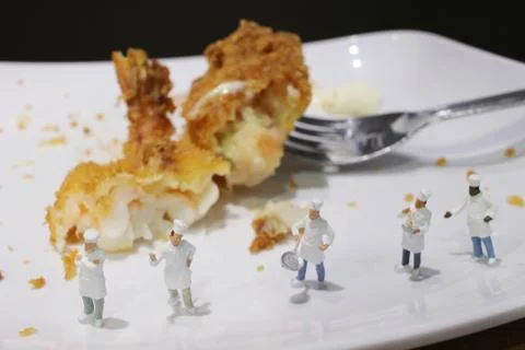 Tiny of cook are talking in the kitchen. Stock Photos