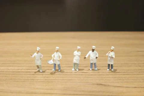 Tiny of cook are talking in the kitchen. Stock Photos