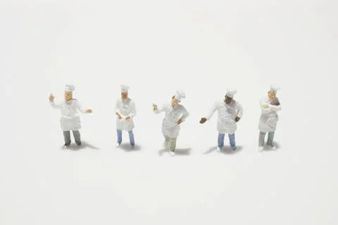 A tiny of cook are talking in the kitchen. Stock Photos