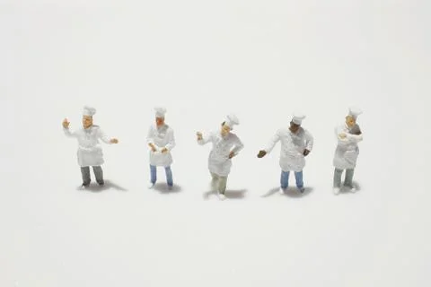 A tiny of cook are talking in the kitchen. Stock Photos