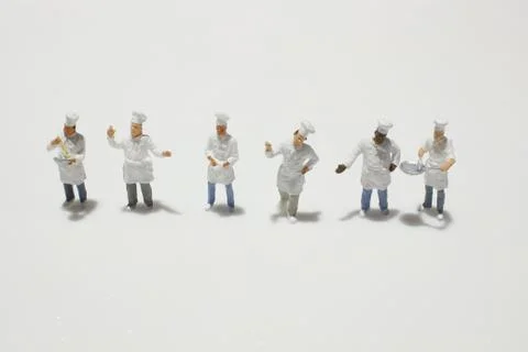 A tiny of cook are talking in the kitchen. Stock Photos
