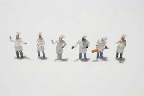 A tiny of cook are talking in the kitchen. Stock Photos
