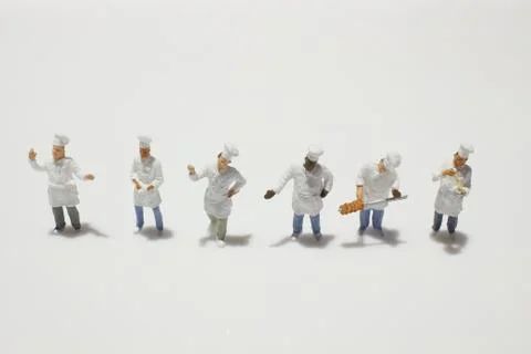 A tiny of cook are talking in the kitchen. 스톡 사진