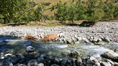 Tiny cute mountain ridge river in rocky field - tourism concept Video stock 243448010