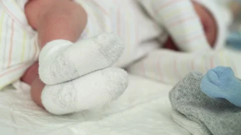 Tiny Cute Newborn Babies Feet In Socks Early First Days Of Life On White Stock Footage 161756744