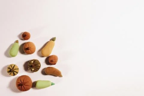 Tiny cute pumpkins and cabbages crafted from modeling dough veggies Stockfoto's