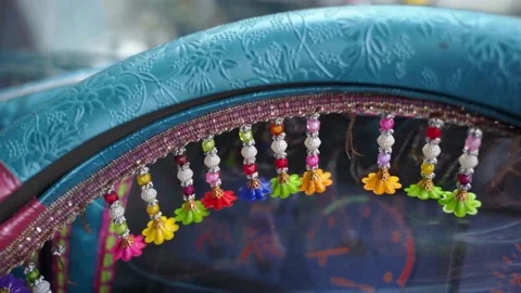 Tiny decorations on a driving wheel inside of driver cabin of a Jingle Truck Stock Footage 132927200