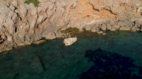 Tiny Dock Under Rocky Cliffs: Aerial Footage Stock Footage 236567462